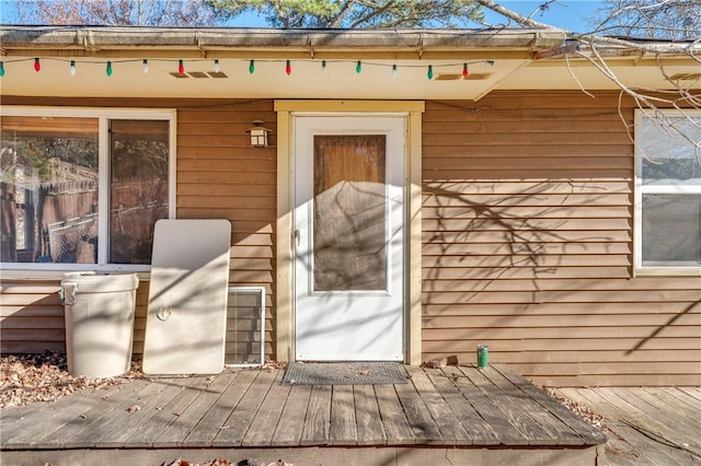 view of exterior entry with a deck