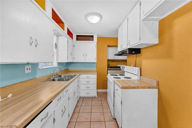 kitchen with white range with electric cooktop, light tile patterned flooring, white cabinetry, and sink