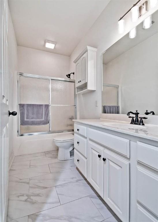 full bathroom with shower / bath combination with glass door, vanity, and toilet