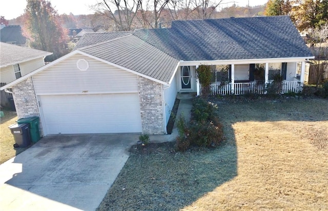 view of front facade with a porch, a garage, and a front yard