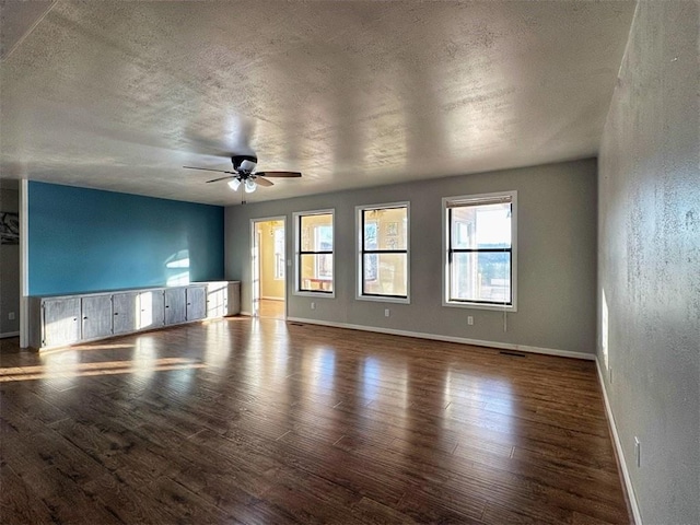 empty room featuring hardwood / wood-style flooring, a textured ceiling, and ceiling fan