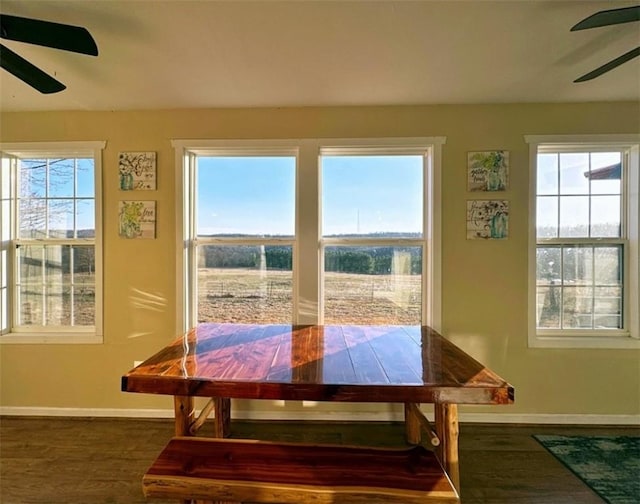 dining area featuring dark hardwood / wood-style floors and ceiling fan