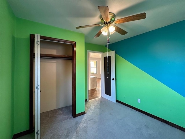 unfurnished bedroom featuring a closet, ceiling fan, and carpet