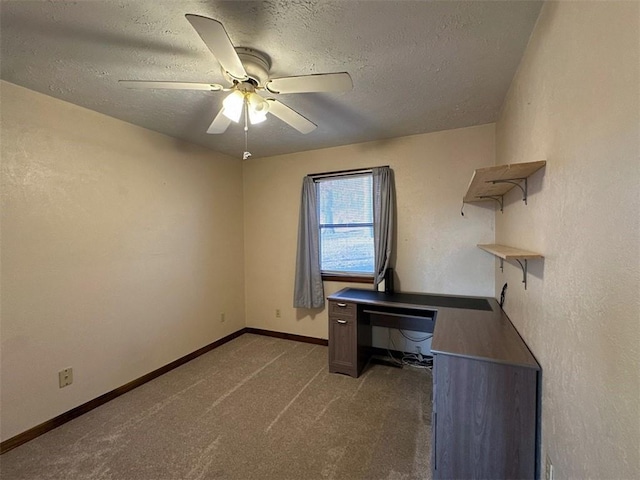 unfurnished office featuring ceiling fan, carpet, and a textured ceiling