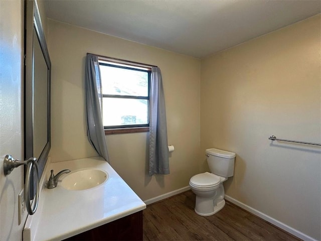 bathroom with vanity, wood-type flooring, and toilet