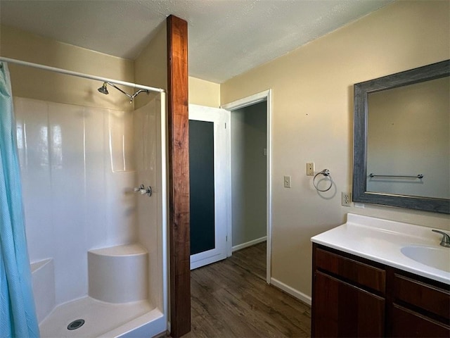 bathroom with vanity, wood-type flooring, and a shower with curtain