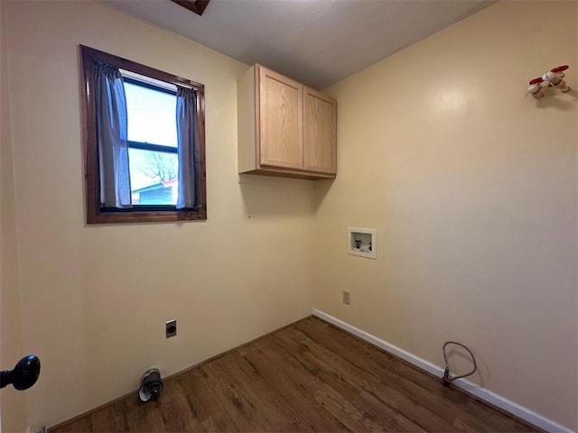 clothes washing area with hookup for a washing machine, dark wood-type flooring, and cabinets