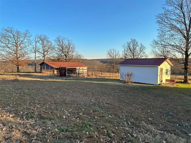 view of yard featuring a rural view and an outdoor structure