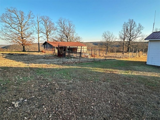 view of yard featuring an outbuilding and a rural view