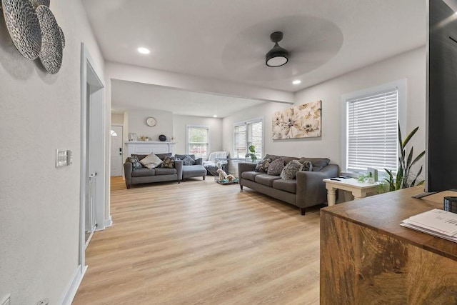 living room featuring ceiling fan and light hardwood / wood-style floors