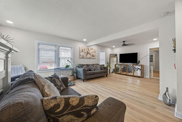 living room featuring ceiling fan and light hardwood / wood-style flooring