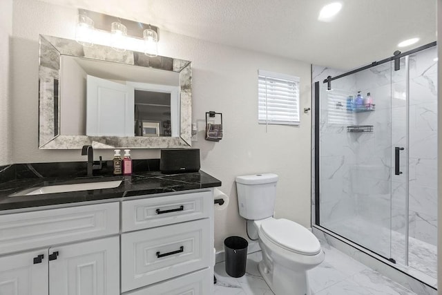 bathroom with vanity, toilet, and an enclosed shower