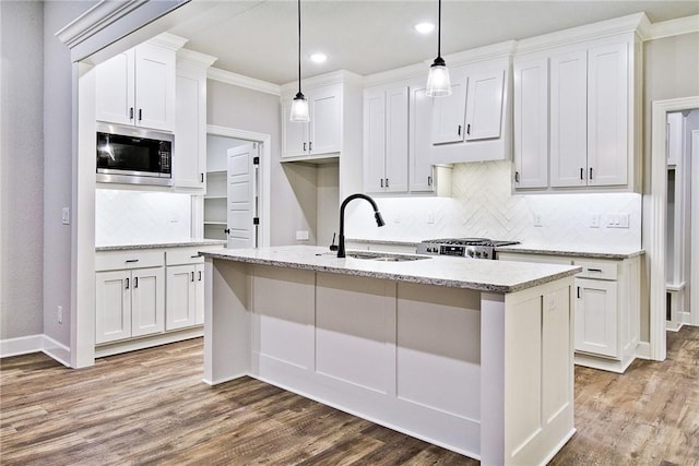 kitchen with white cabinets, sink, an island with sink, and appliances with stainless steel finishes