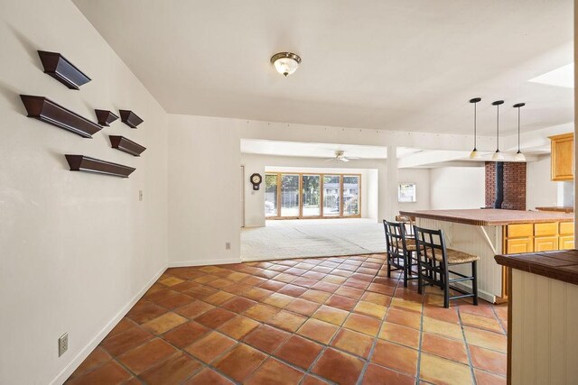 interior space featuring bar and ceiling fan