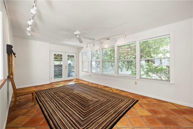 unfurnished sunroom with track lighting, french doors, and ceiling fan