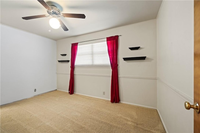 empty room with light colored carpet and ceiling fan