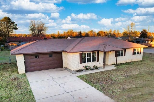 ranch-style house with a garage and a front yard