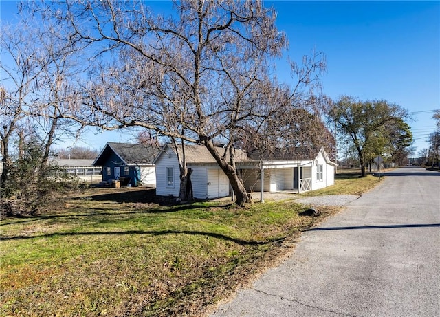 view of property exterior featuring a lawn