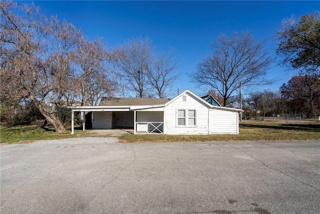 garage with a yard and a carport