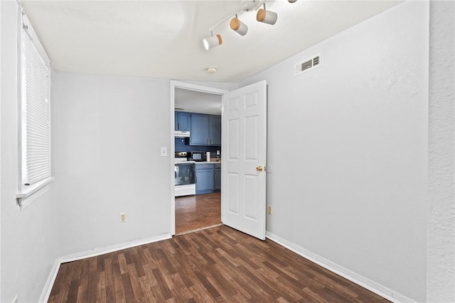 spare room with dark hardwood / wood-style flooring