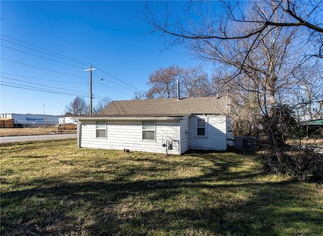 rear view of house featuring a yard