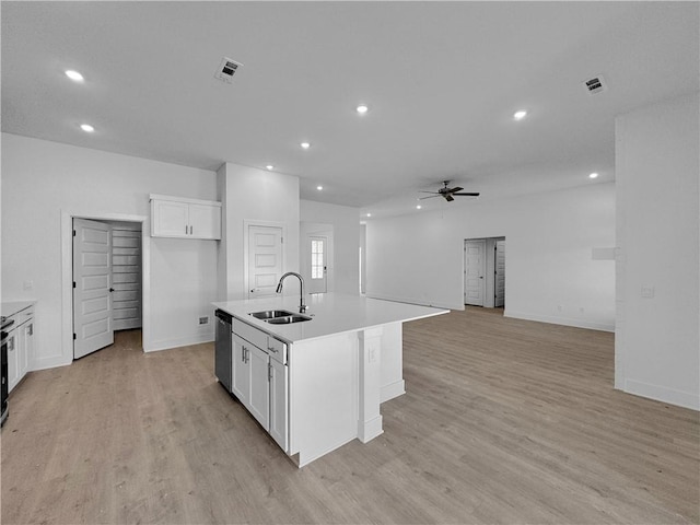 kitchen with dishwasher, white cabinetry, sink, and an island with sink