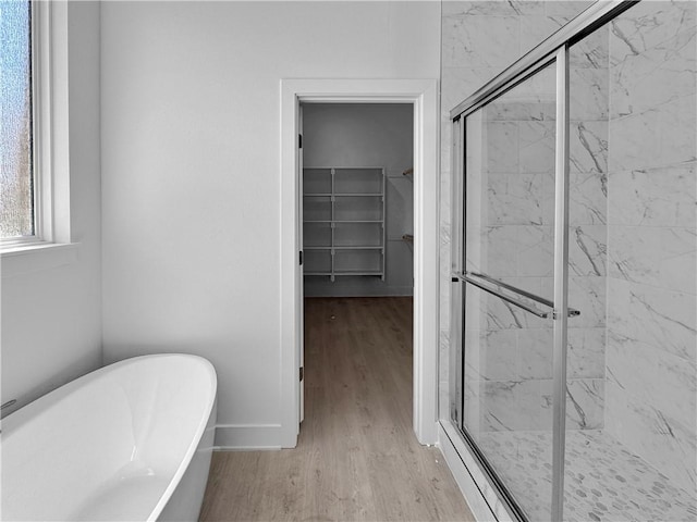 bathroom with separate shower and tub and wood-type flooring