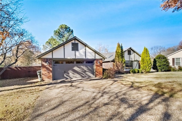 tudor-style house featuring a garage