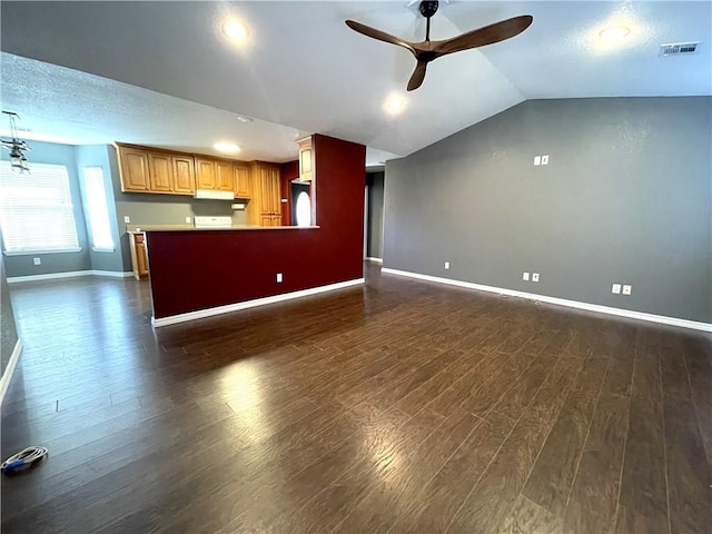 unfurnished living room with a textured ceiling, dark hardwood / wood-style floors, vaulted ceiling, and ceiling fan