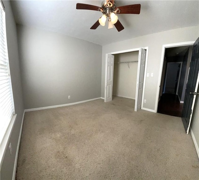 unfurnished bedroom with carpet flooring, ceiling fan, and a closet