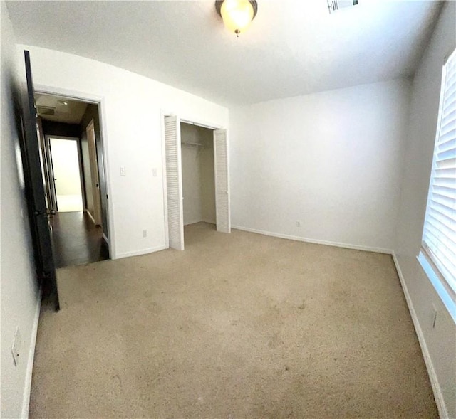 unfurnished bedroom featuring a closet and carpet floors