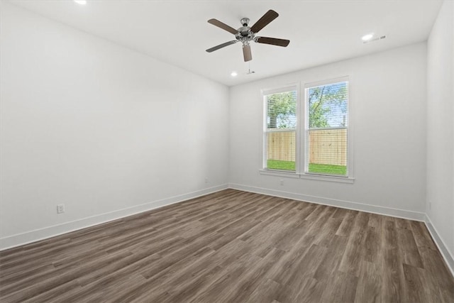 empty room featuring dark hardwood / wood-style floors and ceiling fan