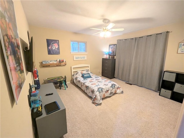 bedroom with ceiling fan and light carpet