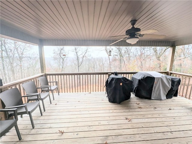 wooden deck featuring ceiling fan and area for grilling