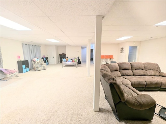 carpeted living room with a paneled ceiling