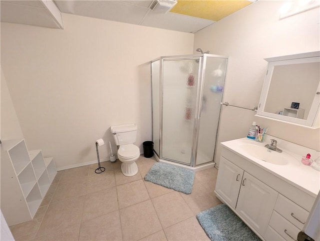 bathroom with tile patterned flooring, vanity, toilet, and a shower with shower door