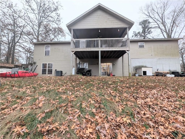 rear view of property featuring a sunroom and cooling unit