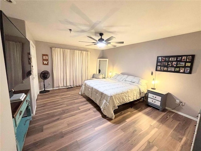 bedroom with hardwood / wood-style floors and ceiling fan