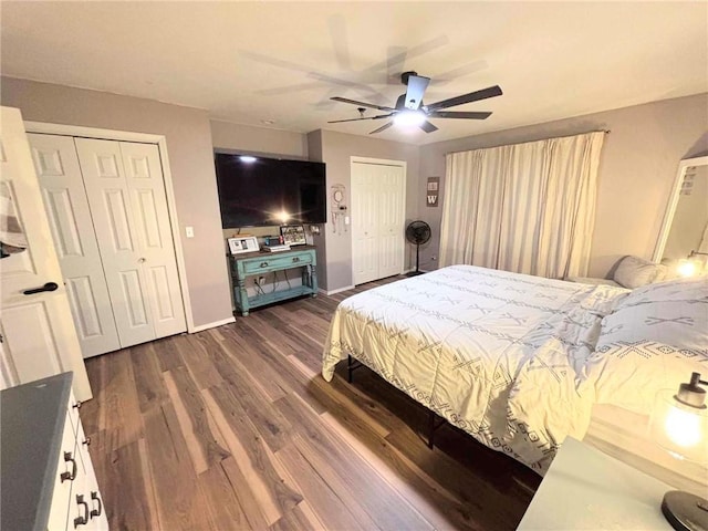 bedroom featuring multiple closets, ceiling fan, and dark wood-type flooring