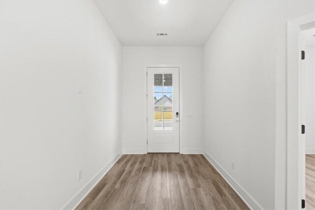 doorway with light wood-type flooring