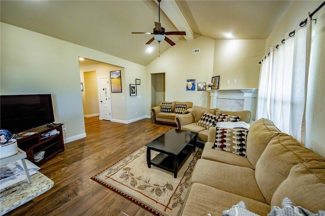 living room featuring lofted ceiling with beams, ceiling fan, and dark wood-type flooring