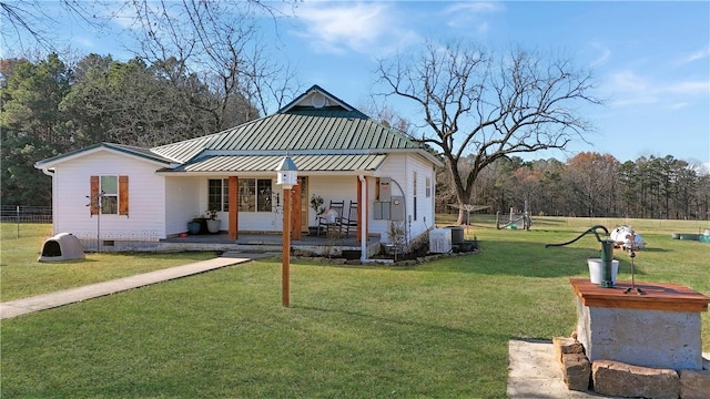 rear view of property with central AC, a yard, and covered porch