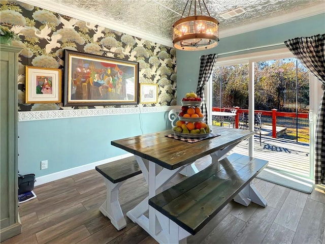 dining room with dark hardwood / wood-style flooring and crown molding