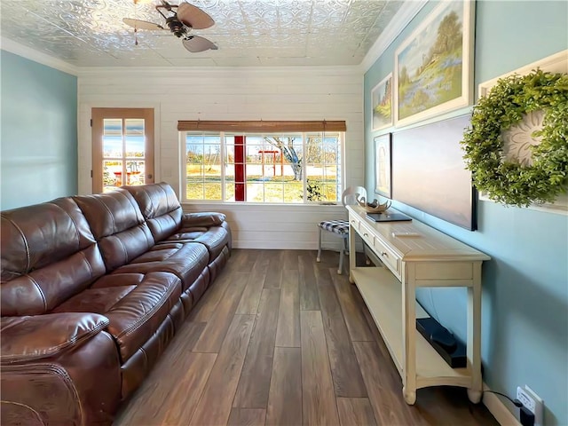 living room with ceiling fan, dark hardwood / wood-style flooring, a textured ceiling, and crown molding