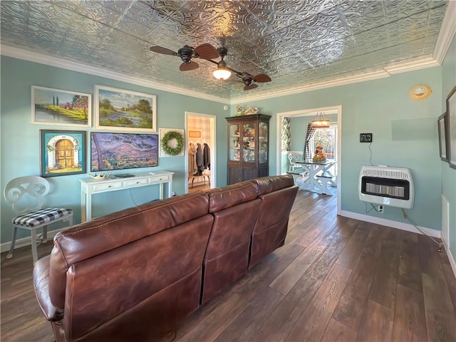 living room with heating unit, dark hardwood / wood-style floors, crown molding, and ceiling fan