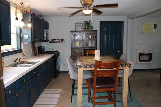 kitchen featuring heating unit, blue cabinets, sink, hanging light fixtures, and black range