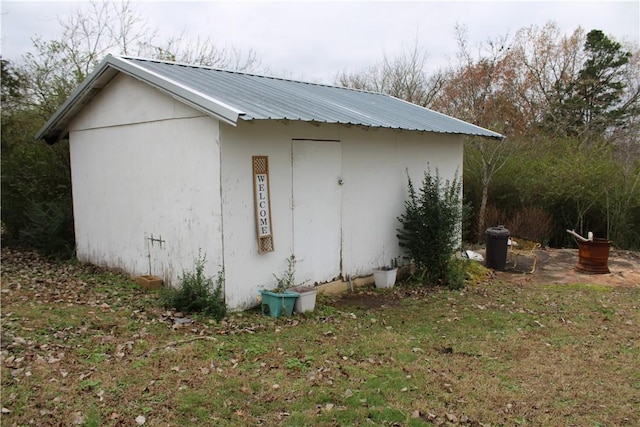 view of home's exterior with a storage shed and a yard