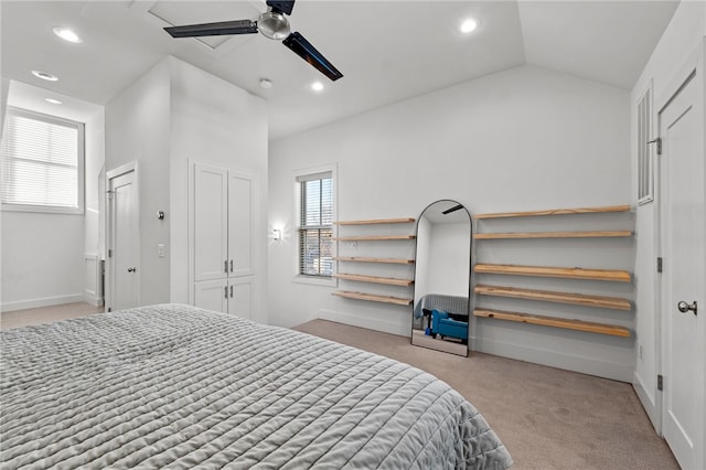 carpeted bedroom featuring ceiling fan, vaulted ceiling, and multiple windows