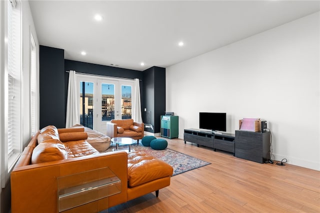 living room featuring light hardwood / wood-style flooring and french doors