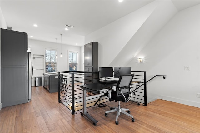 office space with light hardwood / wood-style floors